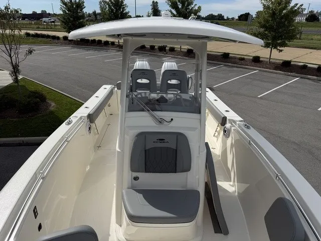 Slide: The Image of The image shows a 2024 Cobia 280 Center Console boat with gray seating and a T-top. - 26