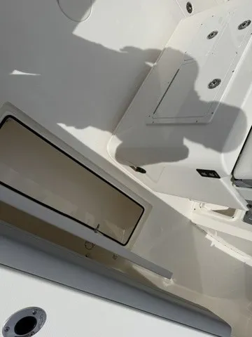 Slide: The Image of The image shows the deck of a 2024 Cobia 280 Center Console boat. - 35