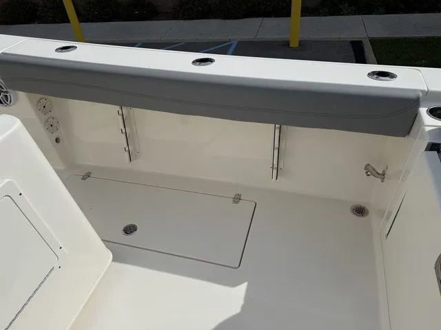 Slide: The Image of The image shows the cockpit of a 2024 Cobia 280 Center Console with gray upholstery. - 14