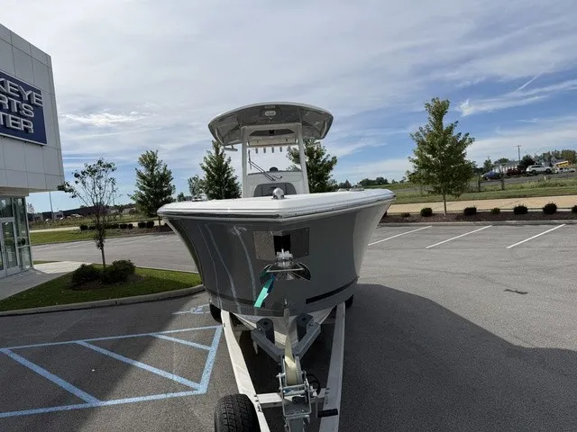 Slide: The Image of A 2024 Cobia 280 Center Console boat is on a trailer in a parking lot. - 3