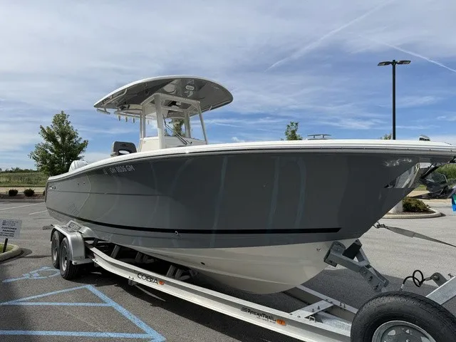 Slide: The Image of A gray 2024 Cobia 280 Center Console boat is on a trailer in a parking lot. - 4