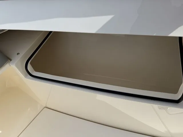 Slide: The Image of An open storage compartment on a 2024 Cobia 280 Center Console boat. - 34