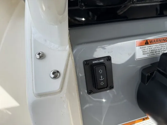 Slide: The Image of Close-up of a windlass switch on a 2024 Cobia 280 Center Console boat. - 20