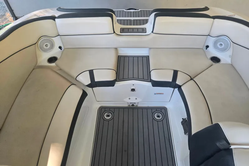 Slide: The Image of 2013 Yamaha Boats AR240 HO interior with beige seating and integrated speakers. - 10