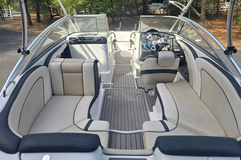 Slide: The Image of 2013 Yamaha Boats AR240 HO interior with sleek seating and modern dashboard design. - 14
