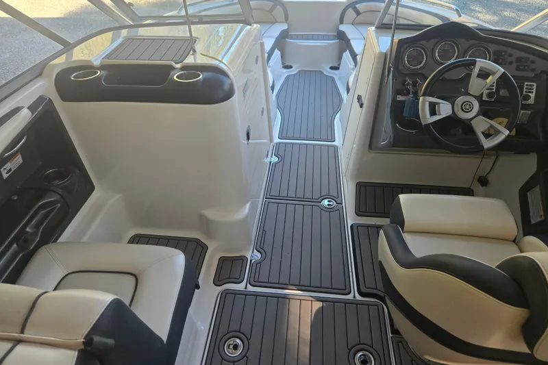Slide: The Image of 2013 Yamaha Boats AR240 HO interior with sleek seating and modern dashboard design. - 9