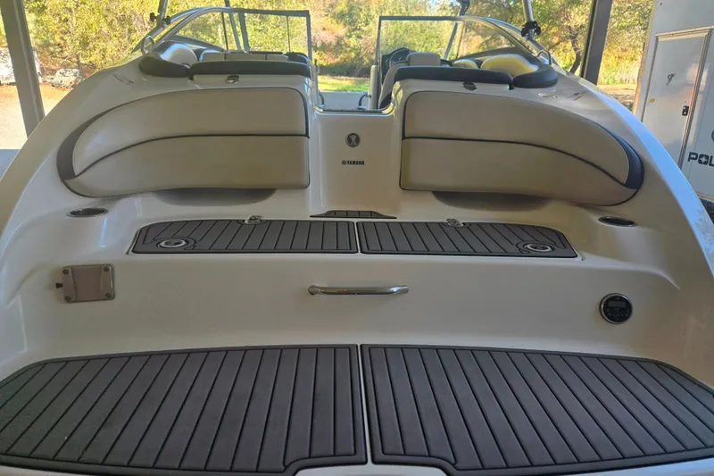 Slide: The Image of 2013 Yamaha Boats AR240 HO rear deck with cushioned seating and non-slip flooring. - 2