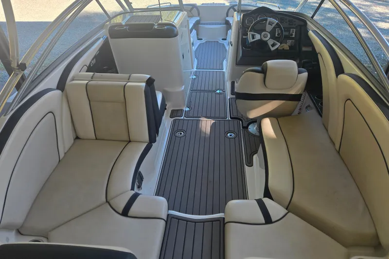 Slide: The Image of 2013 Yamaha Boats AR240 HO interior with beige seating and sleek design. - 12