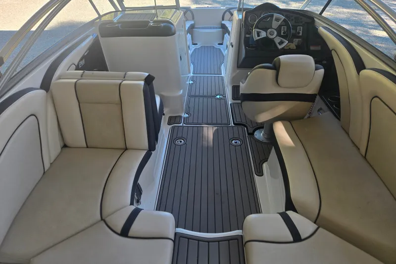 Slide: The Image of 2013 Yamaha Boats AR240 HO interior with beige seating and sleek dashboard design. - 5