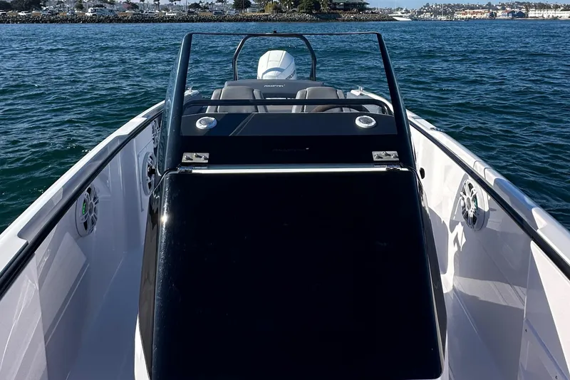 Slide: The Image of 2021 Axopar 22 Spyder boat on water, showcasing sleek design and open deck. - 15