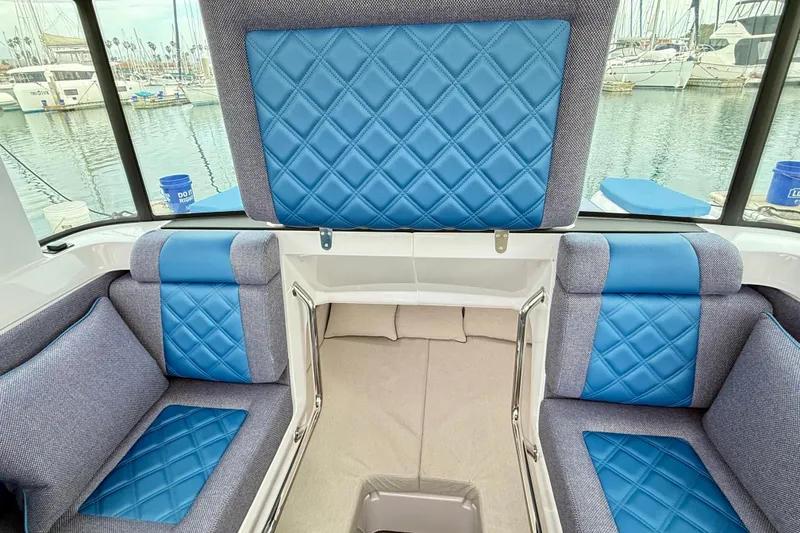 Slide: The Image of Interior of 2025 Axopar 37 XC Cross Cabin with blue quilted seating. - 17
