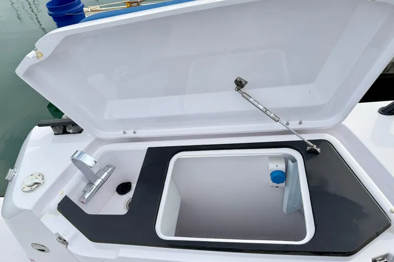 Slide: The Image of Open storage compartment on 2025 Axopar 37 XC Cross Cabin boat. - 52