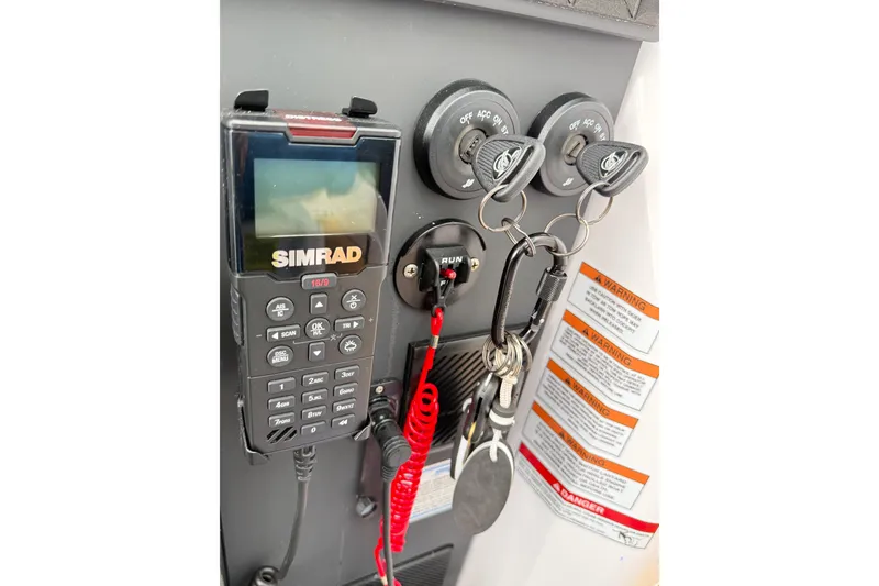Slide: The Image of Control panel of 2025 Axopar 37 XC Cross Cabin with Simrad device and ignition keys. - 28