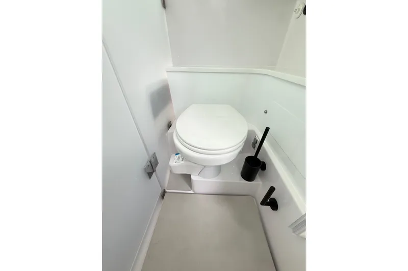 Slide: The Image of 2025 Axopar 37 XC Cross Cabin bathroom interior with modern toilet and accessories. - 36