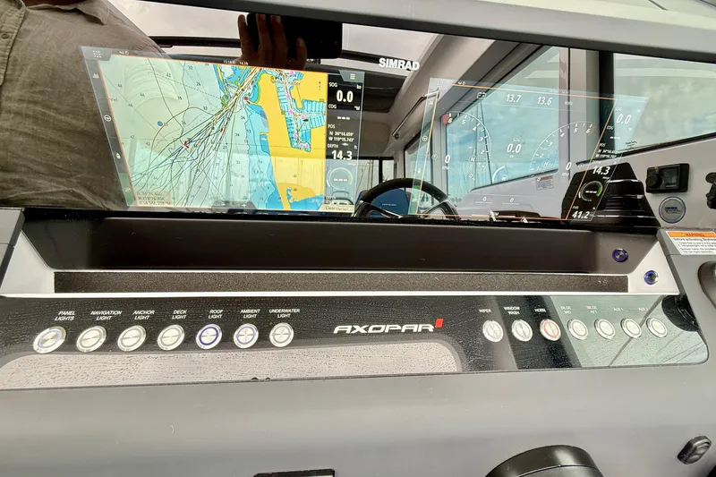 Slide: The Image of 2025 Axopar 37 XC Cross Cabin dashboard with navigation screens and control panel. - 23