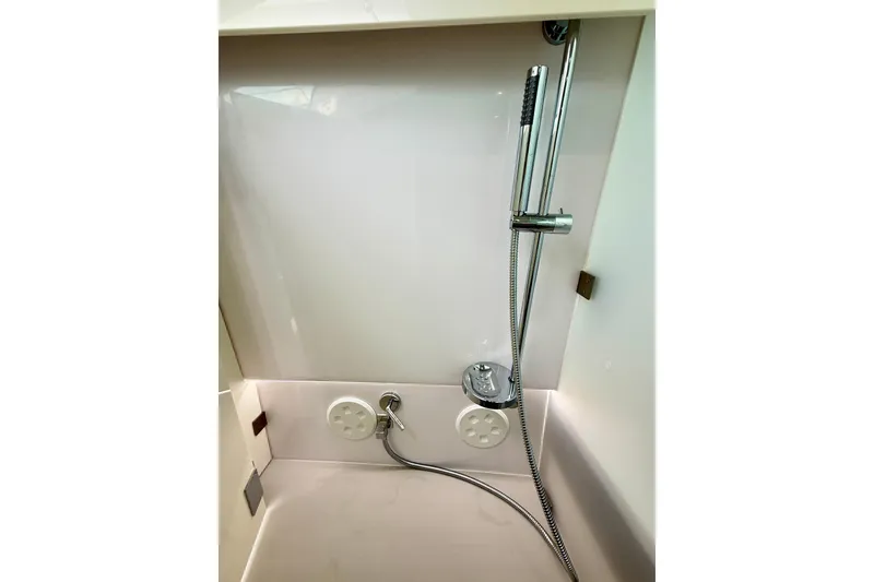 Slide: The Image of 2025 Axopar 37 XC Cross Cabin shower area with modern fixtures and sleek design. - 38
