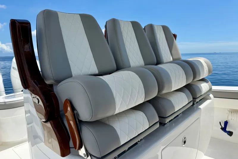 Slide: The Image of 2024 Valhalla V-33 boat seating with elegant gray and white upholstery on a calm sea. - 26