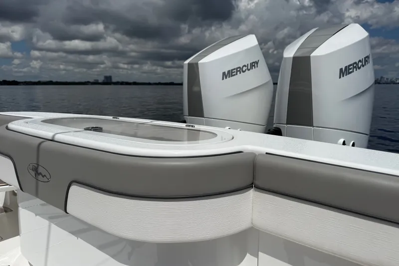 Slide: The Image of 2024 Valhalla V-33 boat with dual Mercury engines on a calm water backdrop. - 15