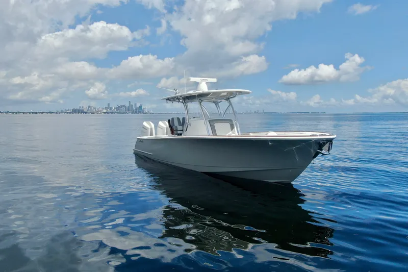 Slide: The Image of 2024 Valhalla V-33 boat on calm water with city skyline in background. - 9