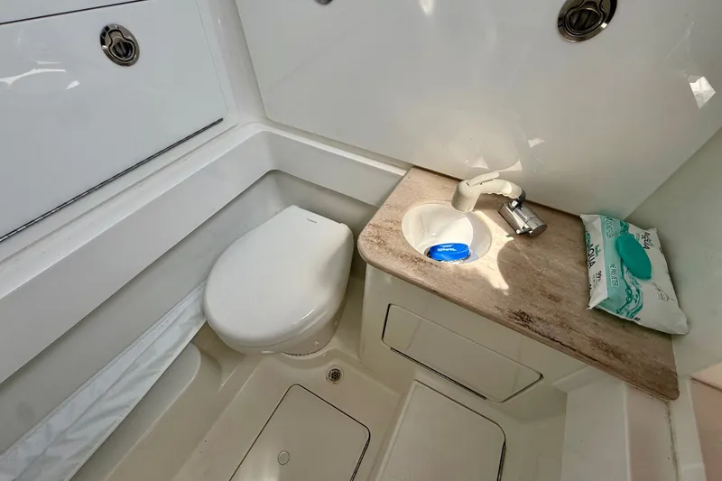 Slide: The Image of 2024 Valhalla V-33 boat bathroom with compact toilet and sink. - 39