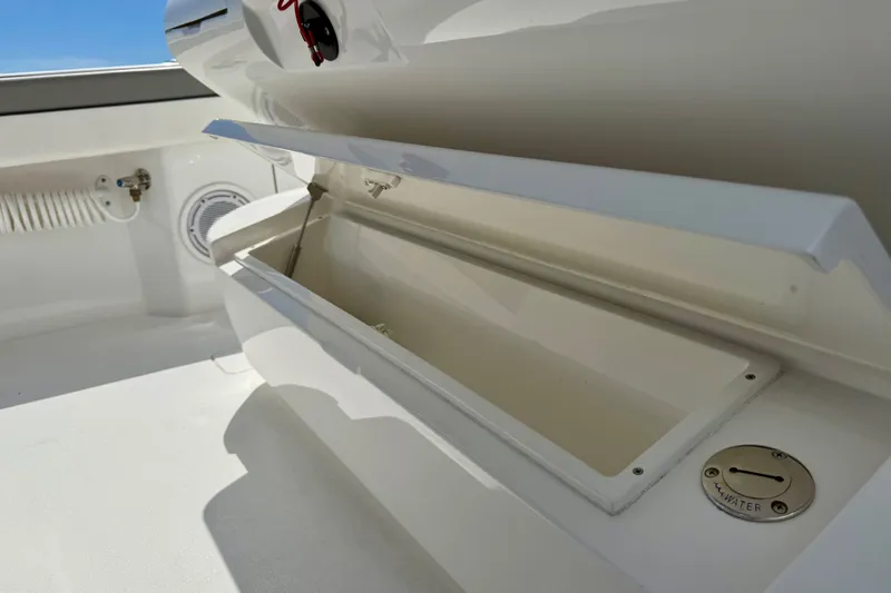 Slide: The Image of 2024 Valhalla V-33 boat storage compartment with open lid and water access. - 34
