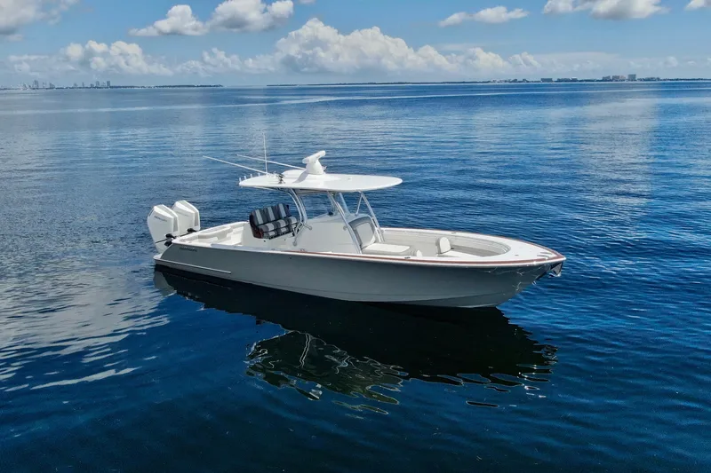 Slide: The Image of 2024 Valhalla V-33 boat on calm blue water under a partly cloudy sky. - 0