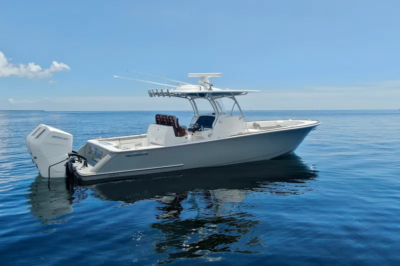 Slide: The Image of 2024 Valhalla V-33 boat on calm ocean waters under clear blue sky. - 11