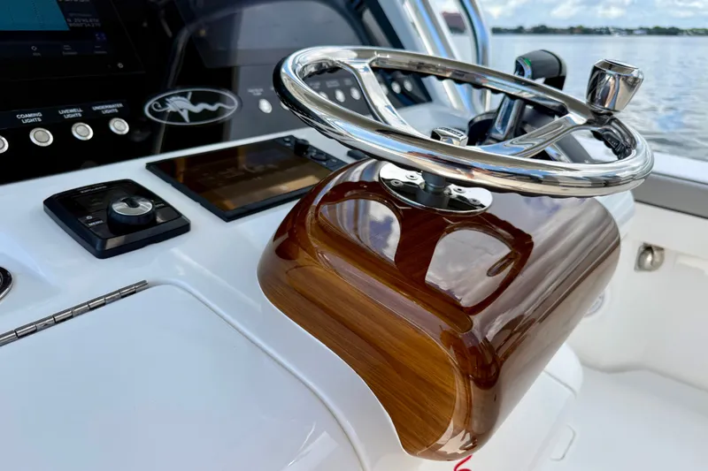 Slide: The Image of Steering wheel of 2024 Valhalla V-33 boat with polished wood and chrome finish. - 22