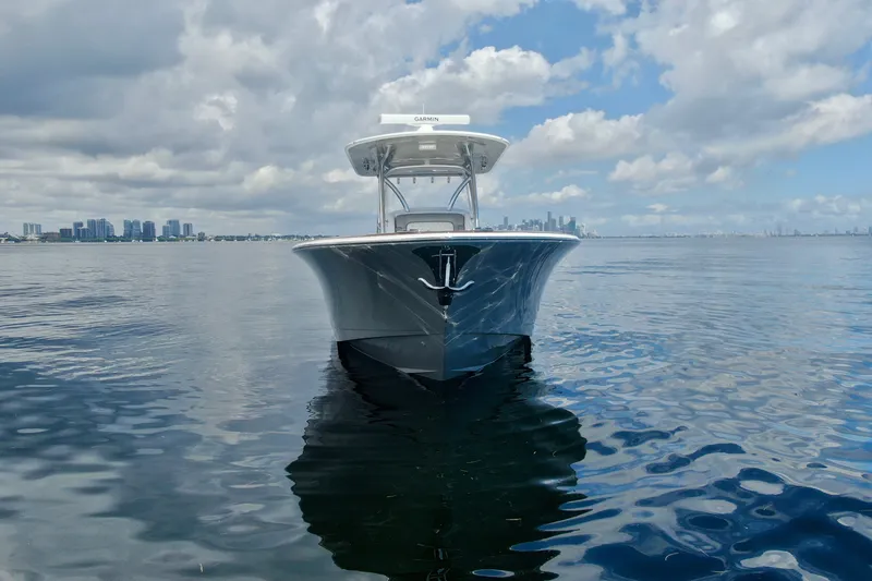 Slide: The Image of 2024 Valhalla V-33 boat on calm water with city skyline in background. - 8