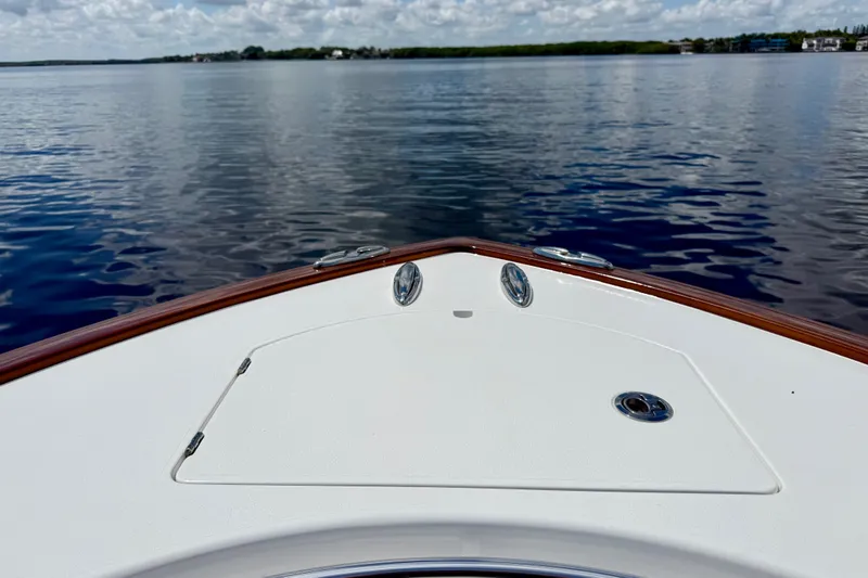 Slide: The Image of Bow of 2024 Valhalla V-33 boat on calm water under cloudy sky. - 30