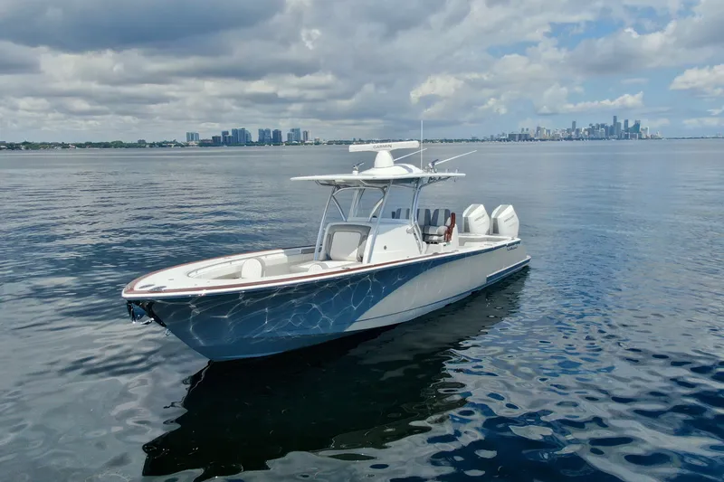 Slide: The Image of 2024 Valhalla V-33 boat on calm water with city skyline in background. - 5