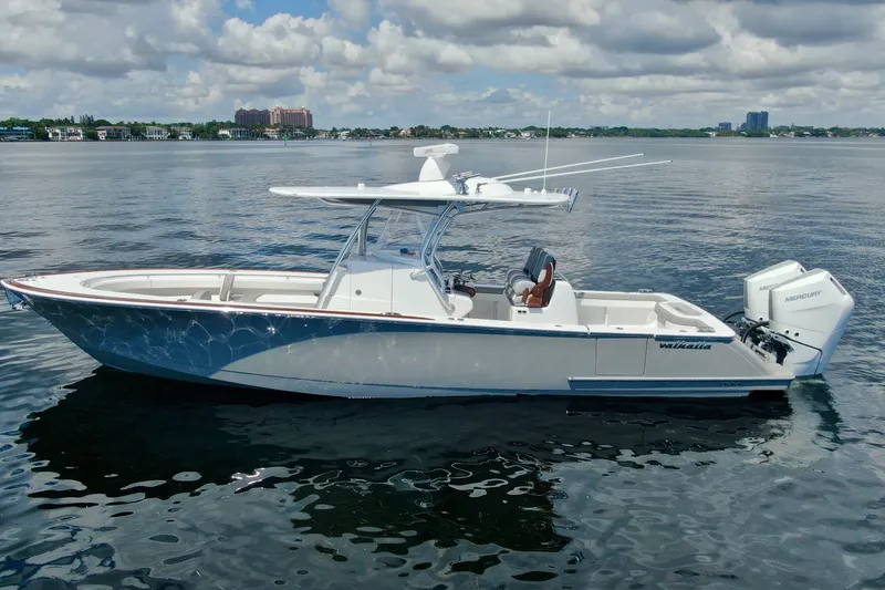 Slide: The Image of 2024 Valhalla V-33 boat on calm water under a cloudy sky. - 4
