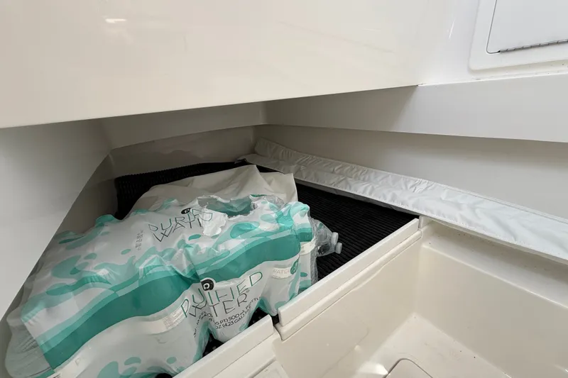 Slide: The Image of Storage compartment in 2024 Valhalla V-33 boat with bottled water packs. - 40