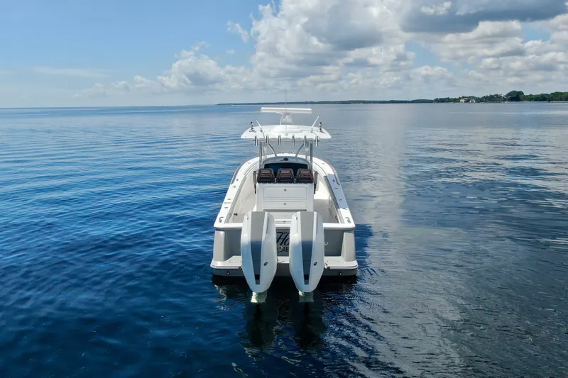 Slide: The Image of 2024 Valhalla V-33 boat on calm water, rear view with twin engines. - 3