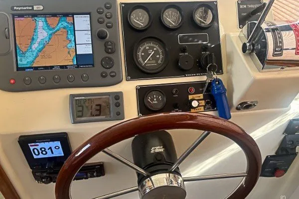 Slide: The Image of 2005 Camano 31 Troll helm with navigation instruments and wooden steering wheel. - 6