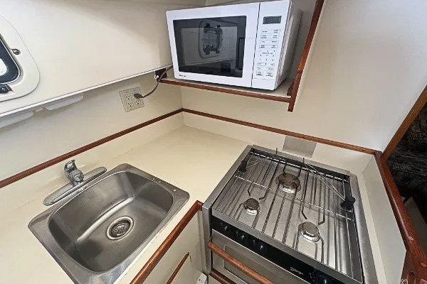 Slide: The Image of Compact kitchen in 2005 Camano 31 Troll boat with sink, stove, and microwave. - 14