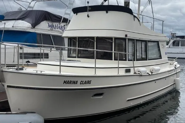 Slide: The Image of 2005 Camano 31 Troll boat docked at marina, named "Marina Claire". - 1