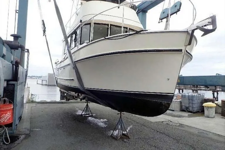 Slide: The Image of 2005 Camano 31 Troll boat lifted on dockside crane for maintenance. - 33