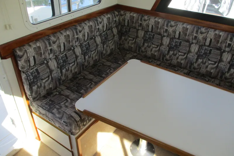 Slide: The Image of 2005 Camano 31 Troll interior with patterned seating and white table. - 14