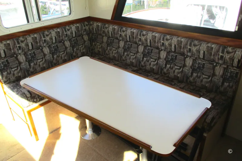 Slide: The Image of Interior of 2005 Camano 31 Troll boat with cushioned seating and dining table. - 7