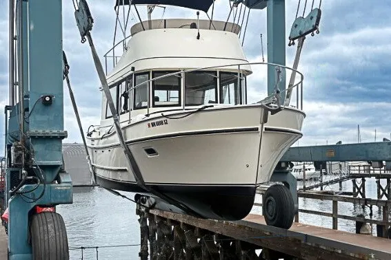 Slide: The Image of 2005 Camano 31 Troll boat being lifted at a marina dock. - 42