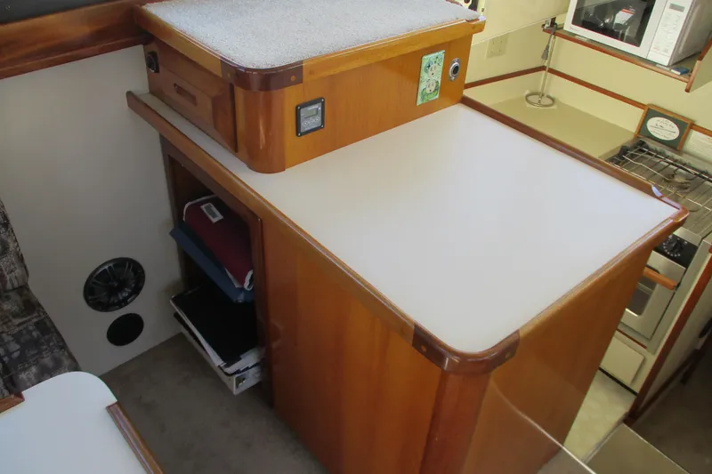 Slide: The Image of Interior of 2005 Camano 31 Troll boat with wooden cabinetry and kitchen area. - 10