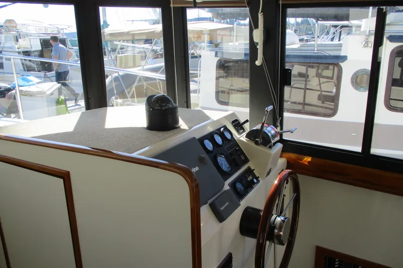 Slide: The Image of Interior helm of 2005 Camano 31 Troll boat with steering wheel and control panel. - 7