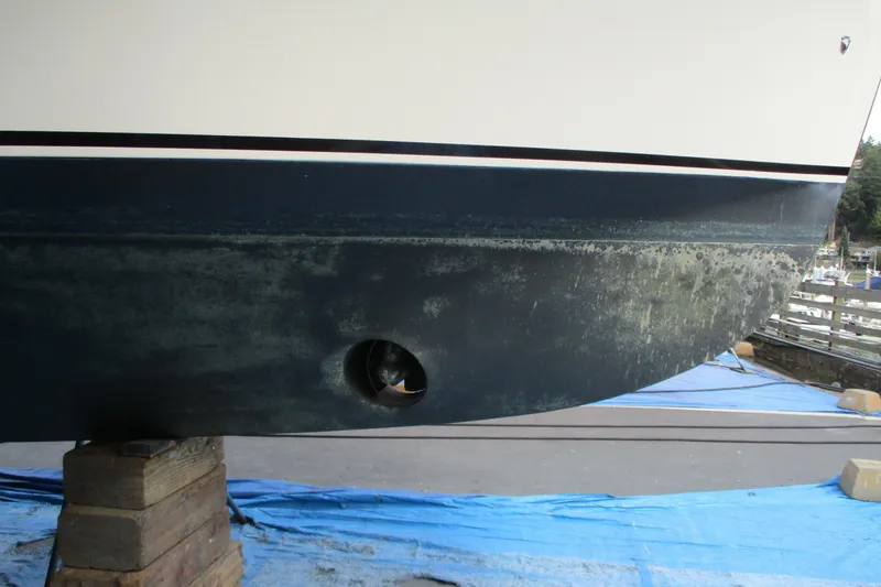 Slide: The Image of 2005 Camano 31 Troll boat hull on blocks, showing marine growth. - 30