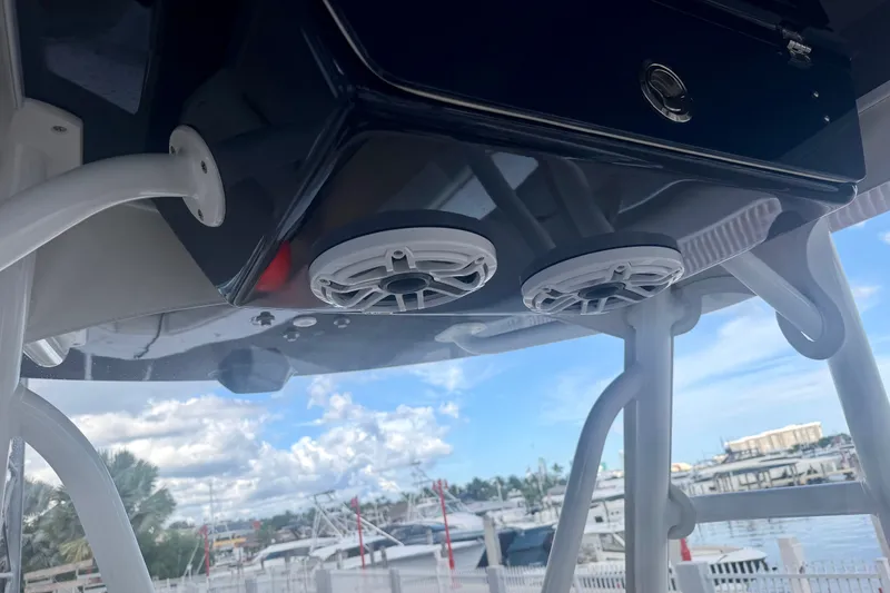 Slide: The Image of 2021 Conch 33 boat speakers and console, marina background, clear sky. - 18