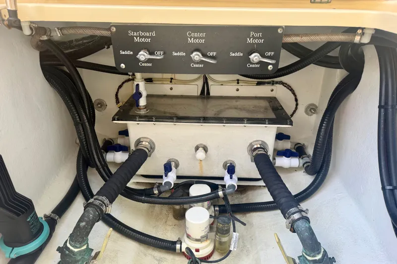 Slide: The Image of Engine compartment of a 2021 Conch 33 boat, showing motor controls and plumbing. - 34