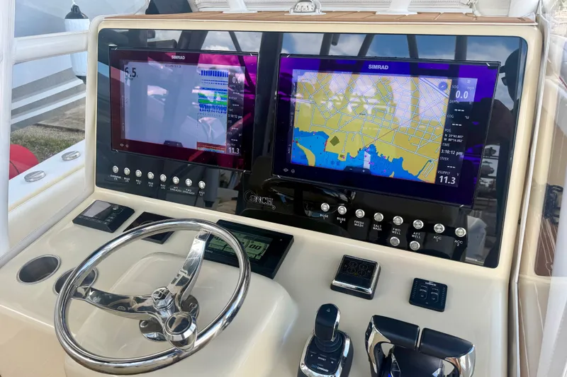 Slide: The Image of Dashboard of 2021 Conch 33 boat with dual Simrad navigation displays. - 14