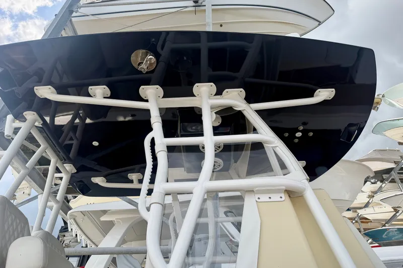 Slide: The Image of 2021 Conch 33 boat with white framework and dark canopy, viewed from below. - 4