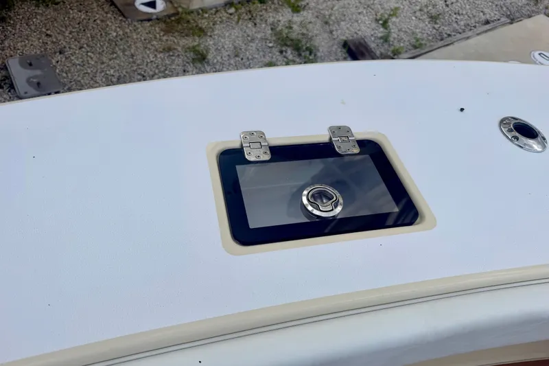 Slide: The Image of Hatch on 2021 Conch 33 boat deck, featuring stainless steel latch and hinges. - 28