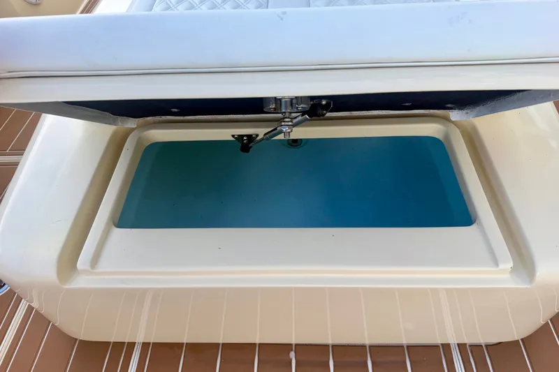 Slide: The Image of Open storage compartment on a 2021 Conch 33 boat, featuring a blue interior. - 30